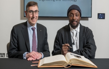 will.i.am, Honorary Fellow of the IET, signs the prestigious 'Roll of Honorary Fellows and Faraday Medallists' book, alongside Nigel Fine, Chief Executive of the IET