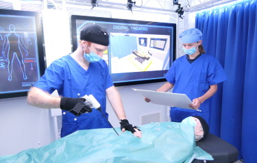 Project engineer Rob Stacey demonstrates how smart tools and CGI movie technology combines in the Digital Operating Theatre demonstrator (Credit: AMRC)