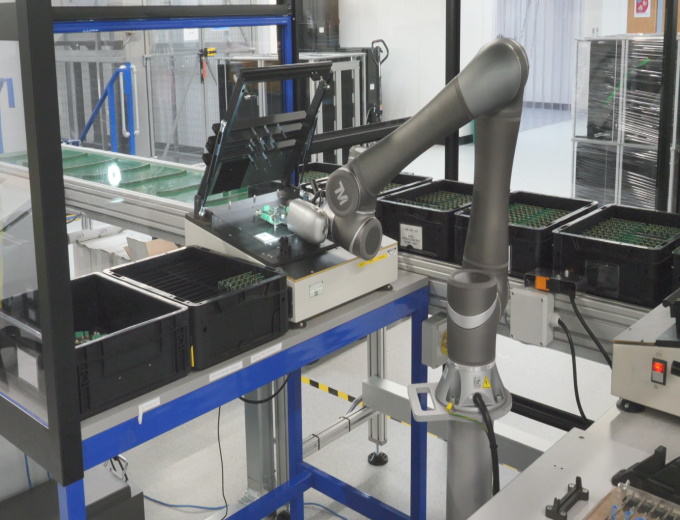 The cobots have special tooling that allow them to open and shut the manual testing equipment