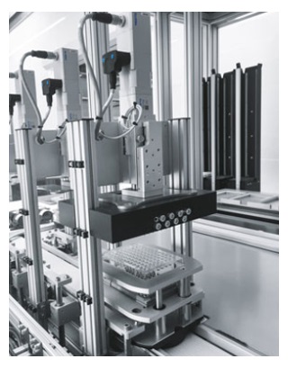 For adding liquid in the microtiter plates in several washing stations, the pipetting head is moved down by an EGSC electric slide For adding liquid in the microtiter plates in several washing stations, the pipetting head is moved down by an EGSC electric slide